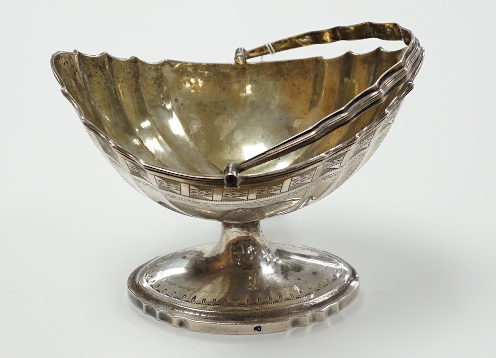 A George III Irish engraved silver bats wing oval shaped pedestal sugar basket, by Richard Sawyer, Dublin, 1803, length 17.5cm, 9oz.